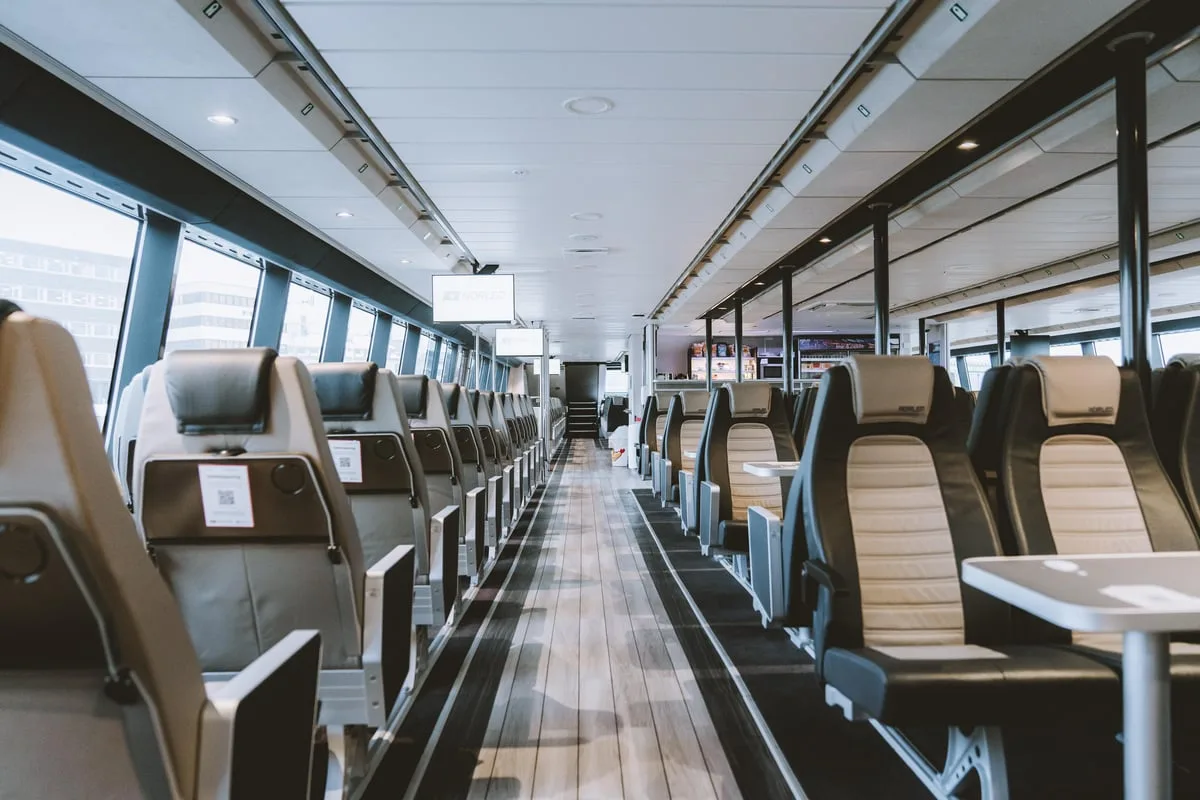 Rows of seats beside panoramic cabin windows