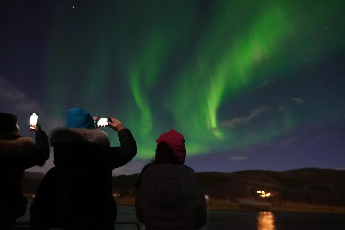 Guests photographing the northern lights
